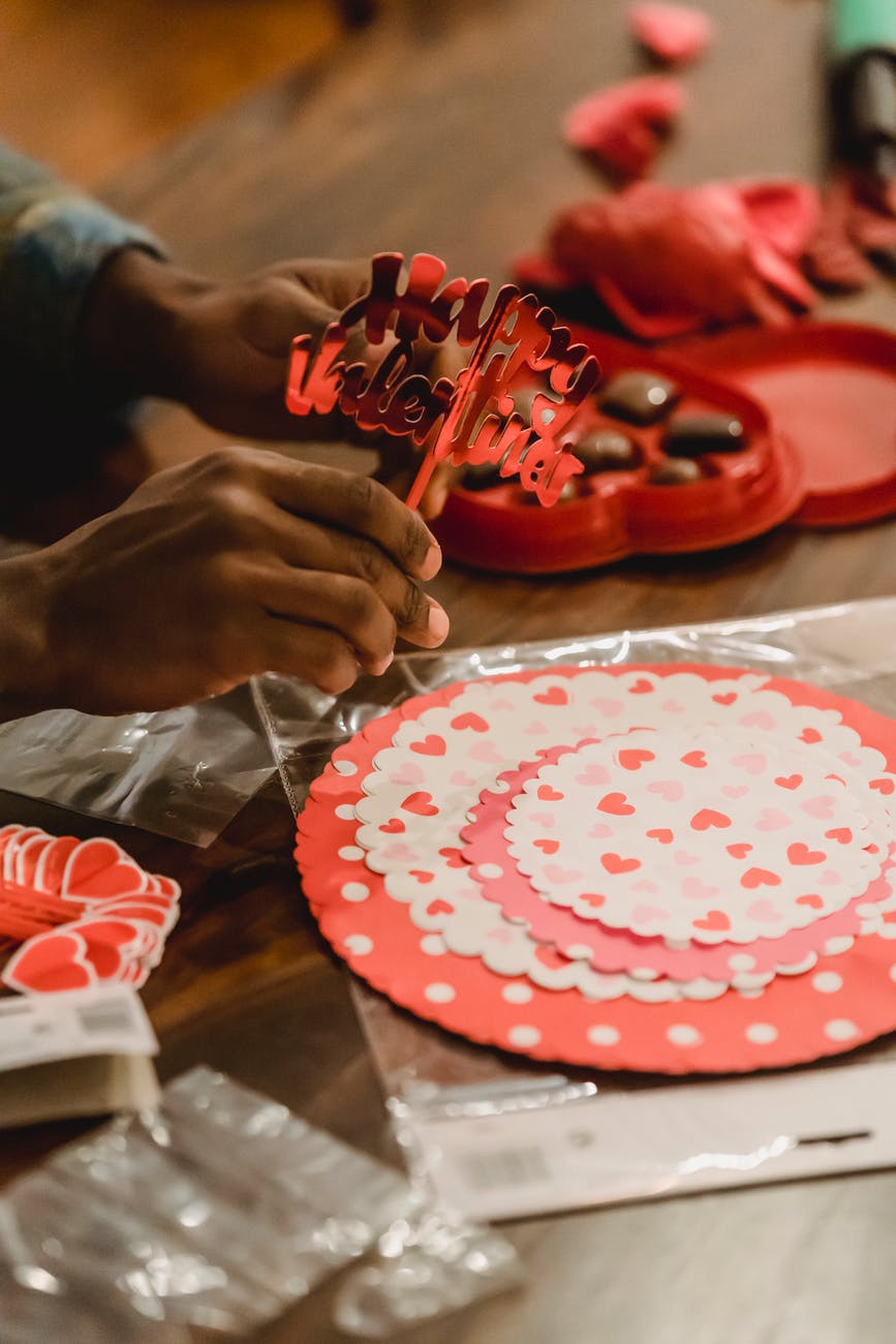 black man making decorations for saint valentine day